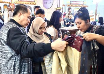 Penjabat (Pj) Gubernur Sumatera Utara (Sumut) Agus Fatoni bersama Pj Ketua Dewan Kerajinan Daerah (Dekranasda) Sumut Tyas Fatoni menghadiri fashion show Pesona Tenun Songket Khas Nias di Open Stage Hall B Jakarta Convention Center Senayan, Jakarta, Sabtu (8/2/2025). Foto/Diskominfo Sumut